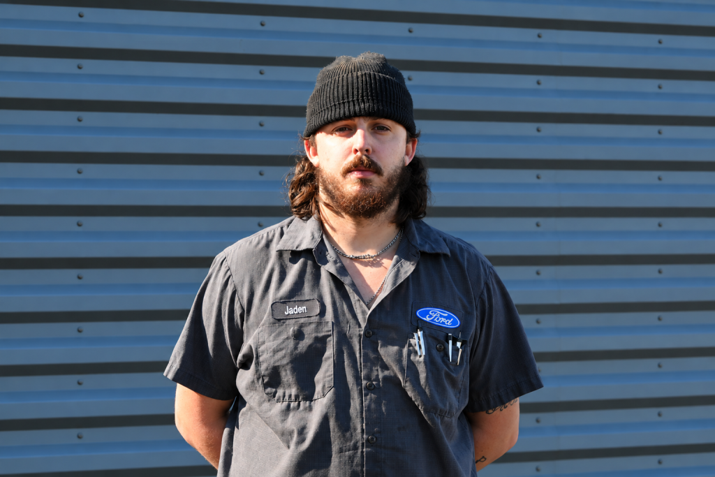 Ford Mechanic Portrait Against Steel Panels