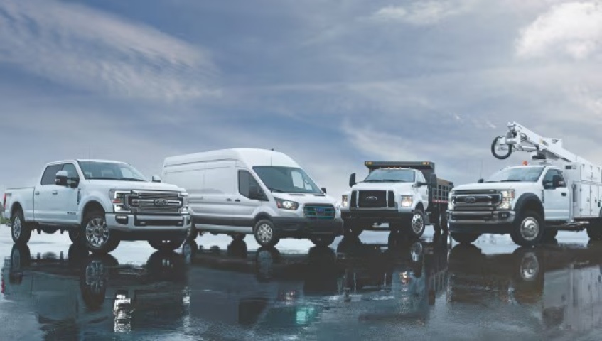 Lineup of Ford commercial vehicles including a Super Duty truck, Transit van, dump truck, and service truck.