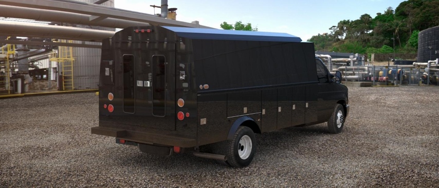 Black Ford E-Series van with utility upfit parked at an industrial facility.