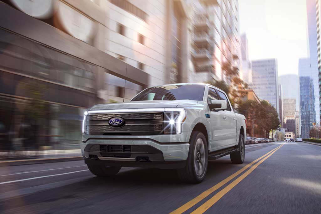 An F-150 Lightning being driven in the city